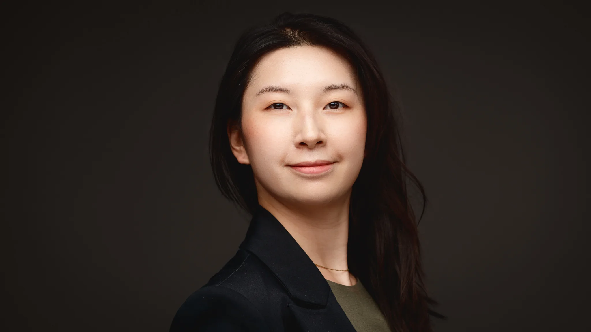 Professional headshot of woman with long black hair