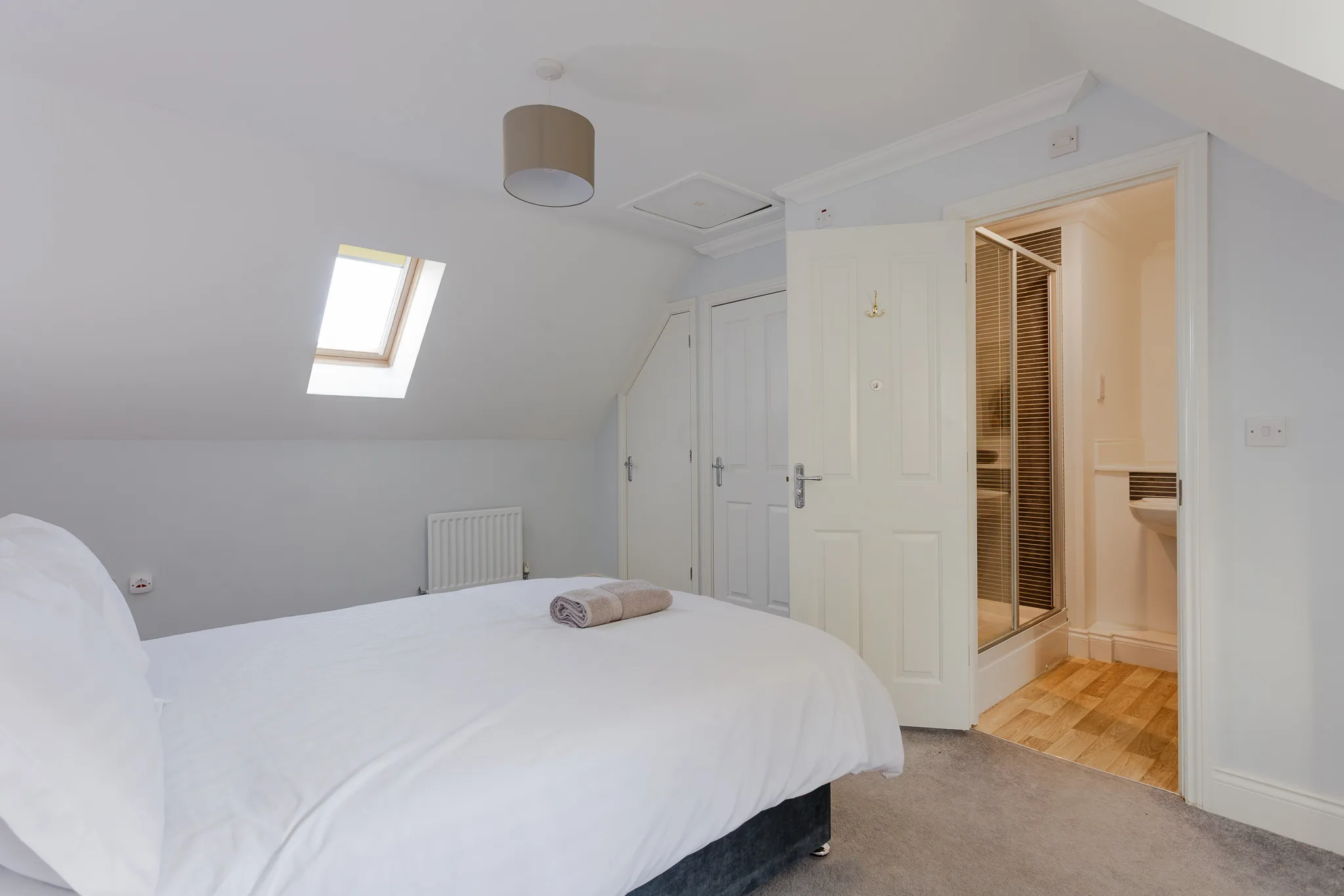 Modern attic bedroom with skylight and ensuite bathroom
