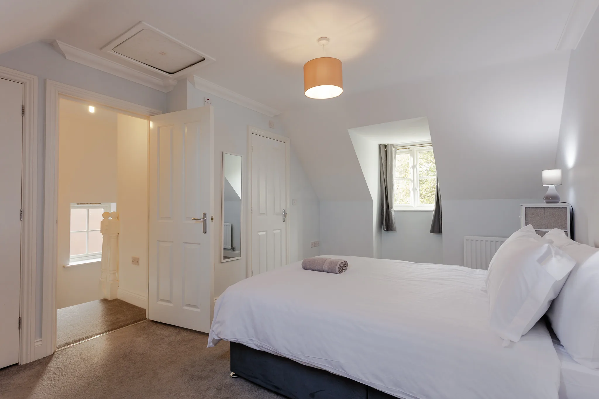 Modern bright bedroom with en-suite bathroom and skylights