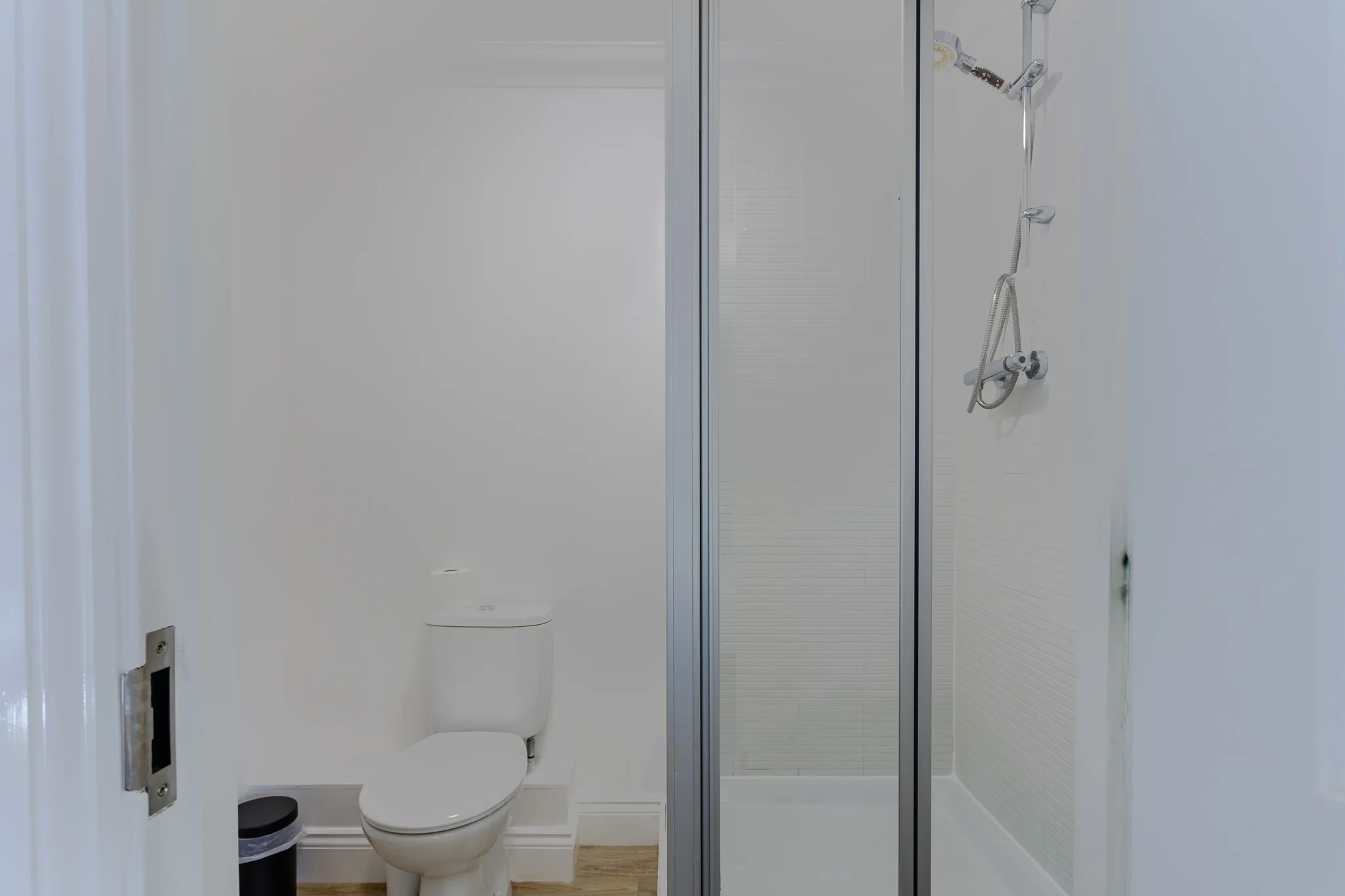 Modern bathroom with toilet and glass shower enclosure