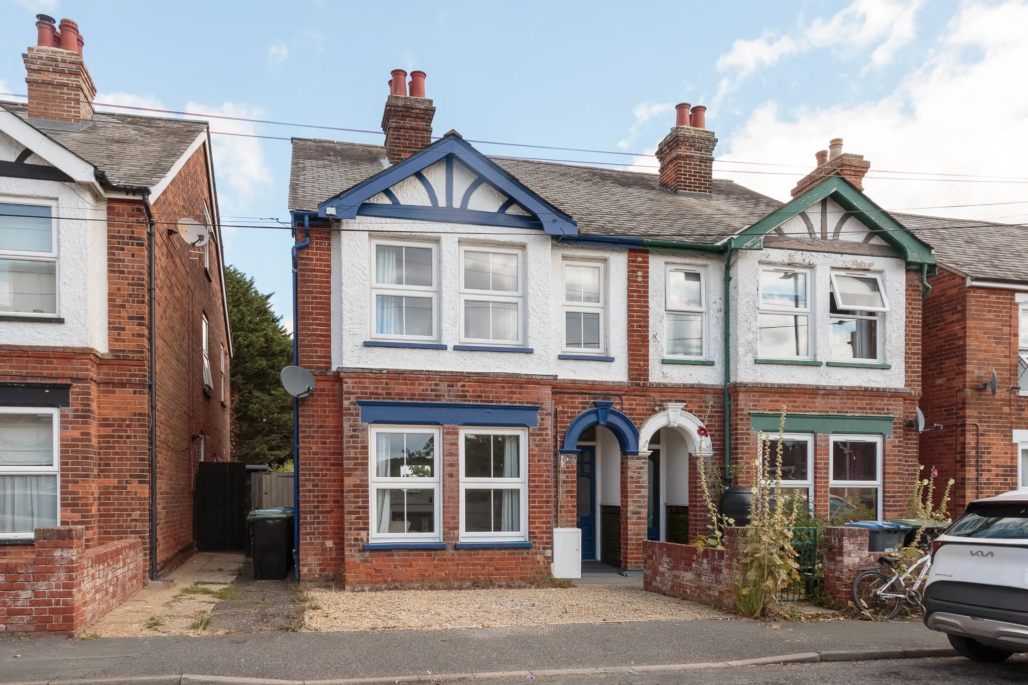 Row of Victorian brick terraced houses with white gables