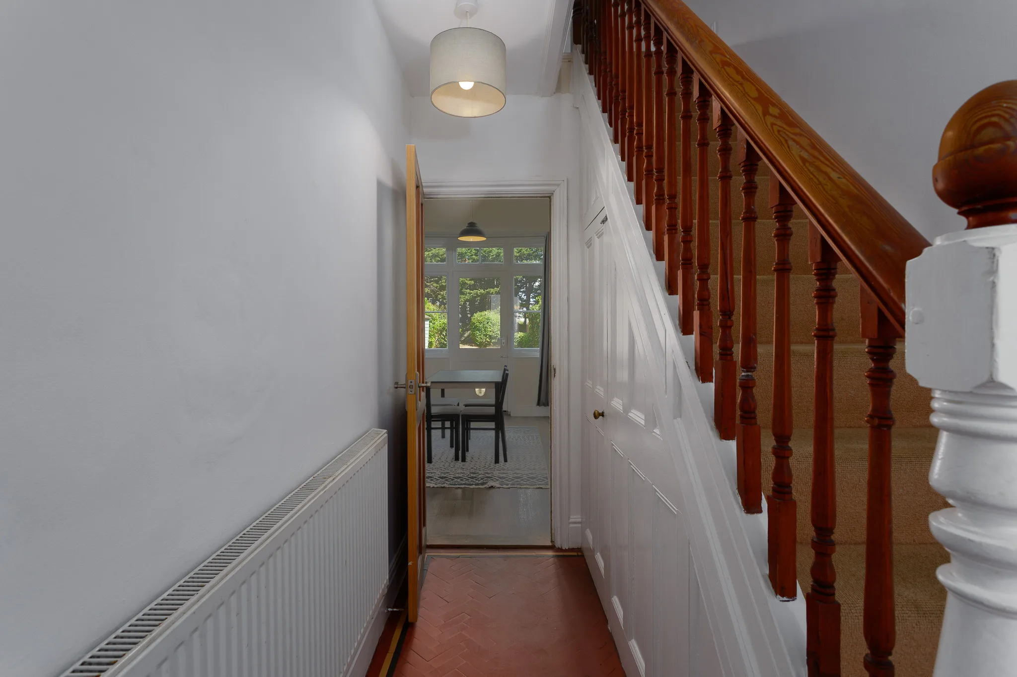 Bright hallway with wooden staircase and natural light