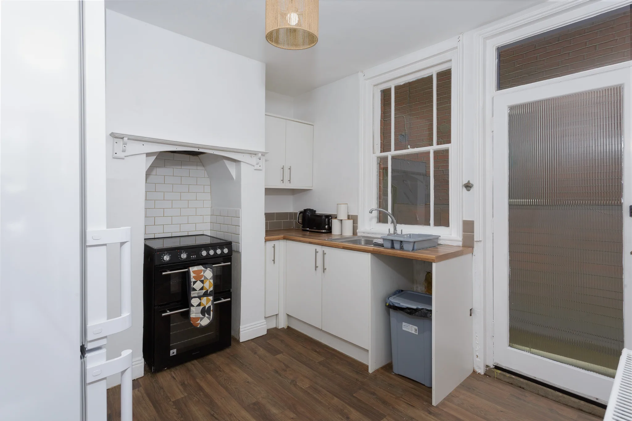 Modern white kitchen with black range cooker and wooden worktops