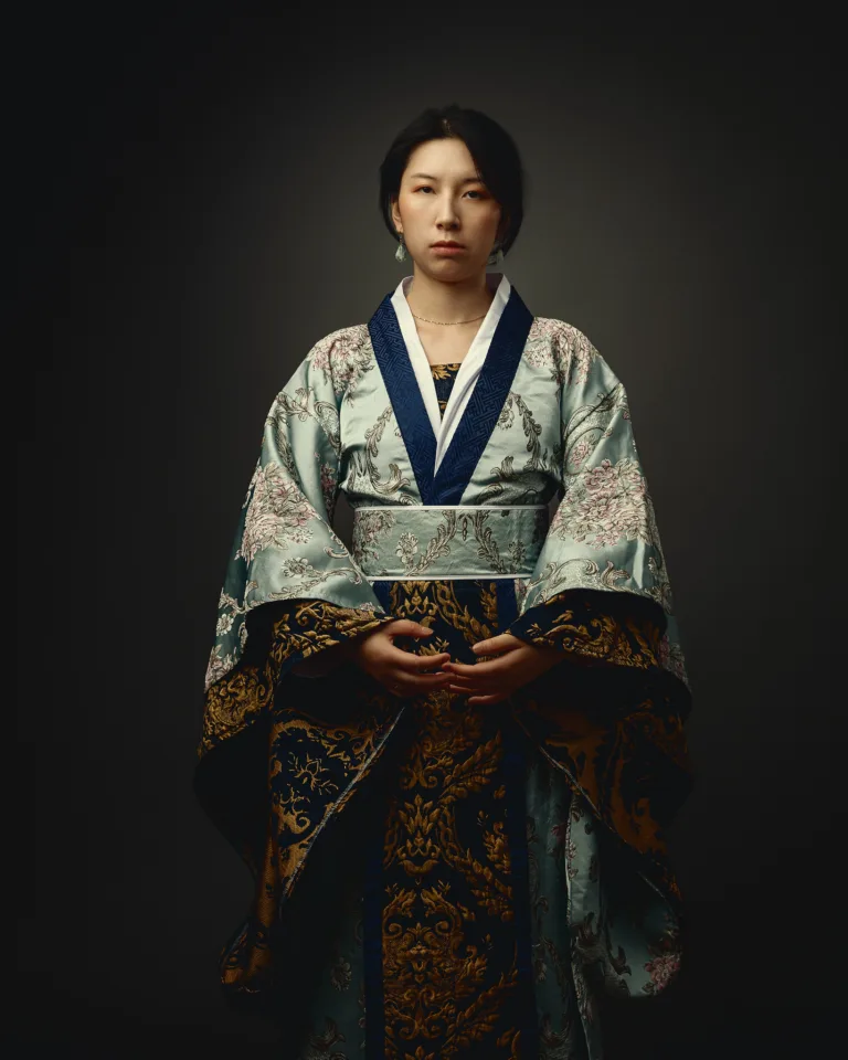 Woman wearing traditional Asian hanbok with ornate embroidered details