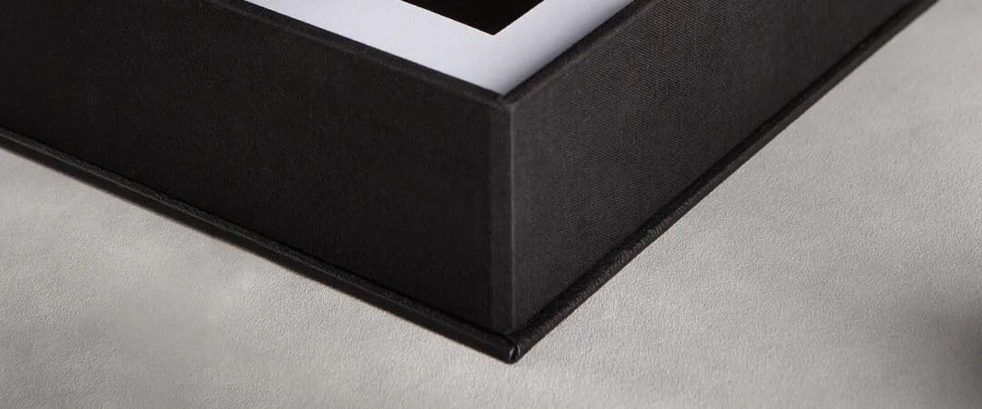 An open folio box of matted prints